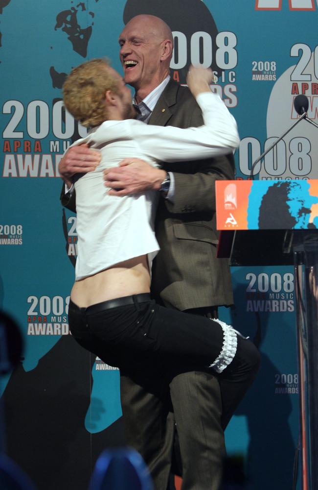 Daniel Johns jumps onto then Federal Arts Minister Peter Garrett after winning Song of the Year at 2008 APRA Music Awards at the Hilton Hotel. Picture: NCA.