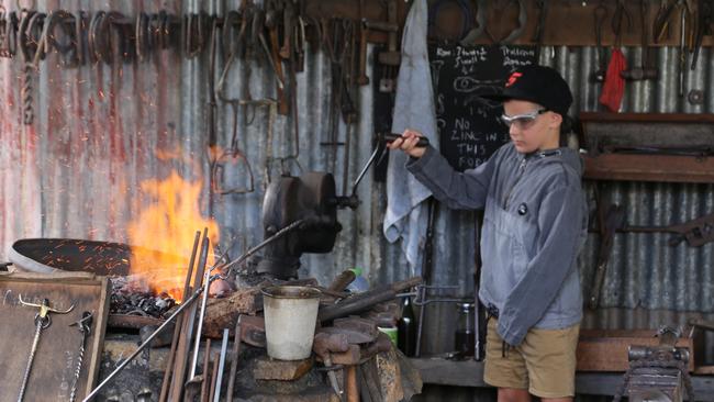 Mareeba boy Domenic Carusi, 8, helped out at the Blacksmith shop at the Historic Village Herberton Pioneer Weekend, which is set for May 7 and 8 in 2022. PHOTO: Bronwyn Wheatcroft.