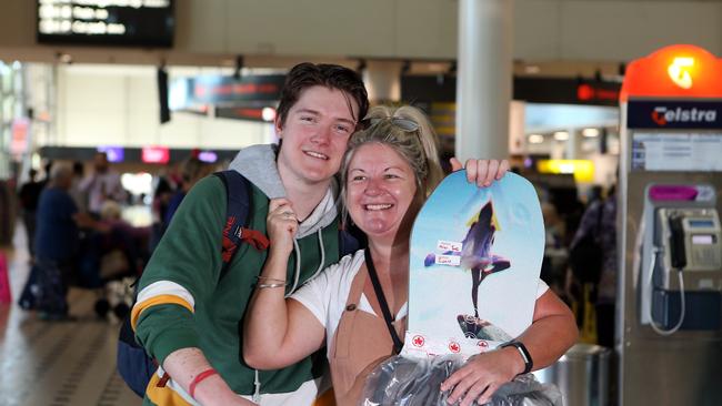 Jacqui Norvill (right) welcomes her son Sam home at the Brisbane International Airport. AAP Image/Richard Gosling