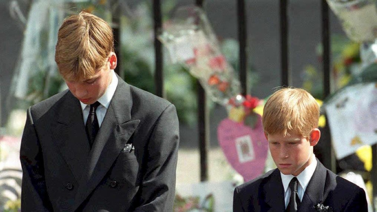 Prince William and Prince Harry bow their heads as their mother's coffin is taken out of Westminster Abbey (Photo by ADAM BUTLER / POOL / AFP)