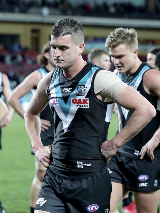 Tom Rockliff and Ollie Wines show their disappointment after Sunday’s loss. Picture Sarah Reed