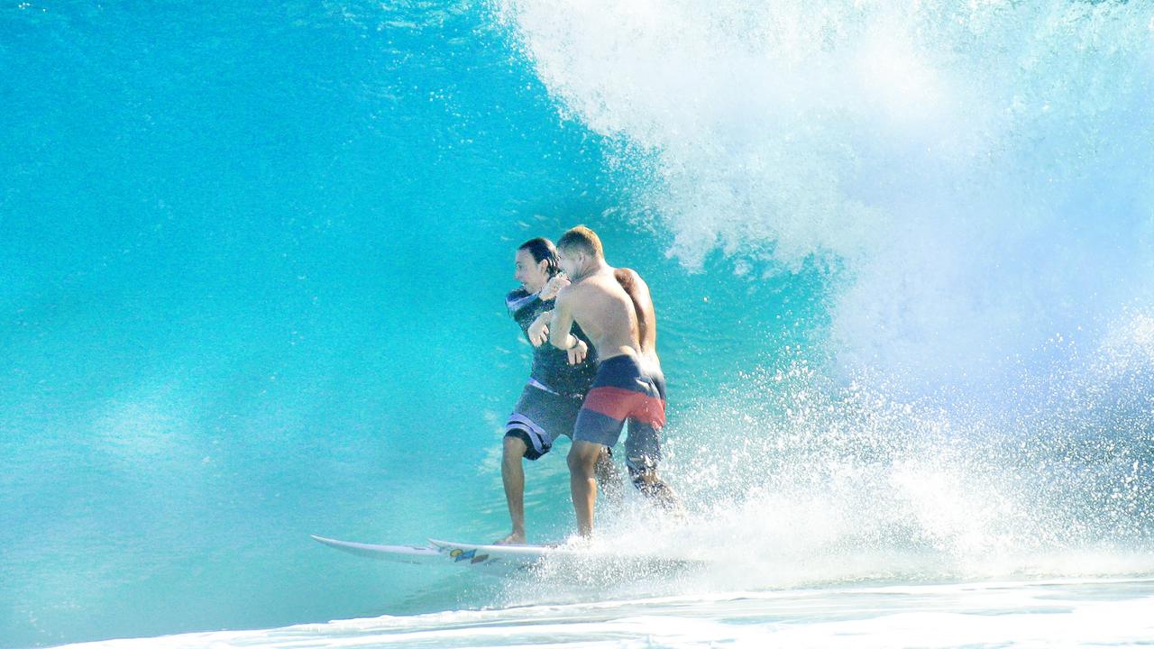 The surfers tussle on top of their boards. Picture: Scott Powick