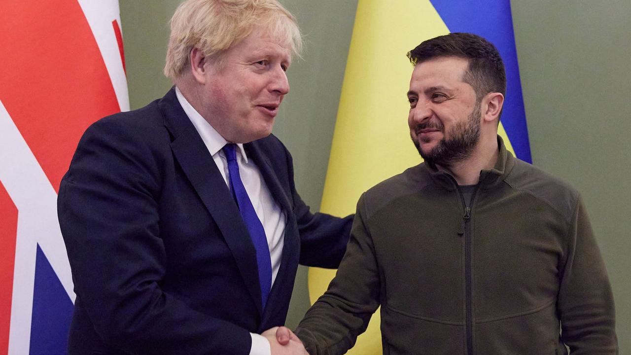 Ukrainian President Volodymyr Zelensky (R) shaking hands with British Prime Minister Boris Johnson ahead of their meeting in Kyiv. (Photo by Stringer / UKRAINIAN PRESIDENTIAL PRESS SERVICE / AFP)