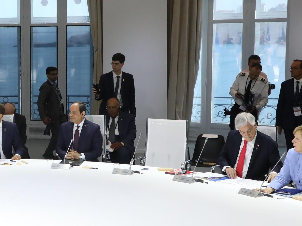 President Trump’s empty chair between Egyptian President Abdel Fattah al-Sissi and Chilean president Sebastian Piniera. Picture: Ludovic MARIN / POOL / AFP.