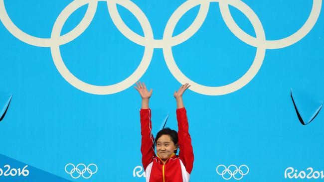 Gold medallist Qian Ren celebrates on the podium.