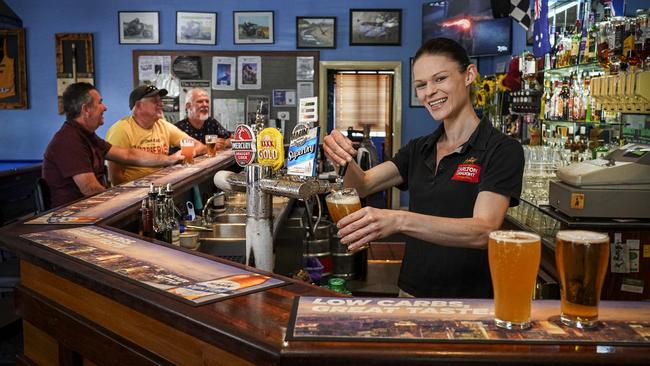 Lobethal Hotel Duty Manager Zoe Watkins serves in the main bar. Picture: AAP / Mike Burton