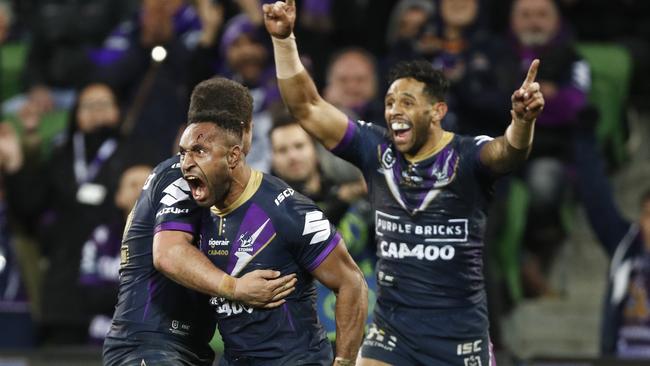 Justin Olam of the Storm celebrates a try during the Round 17 against the Sharks