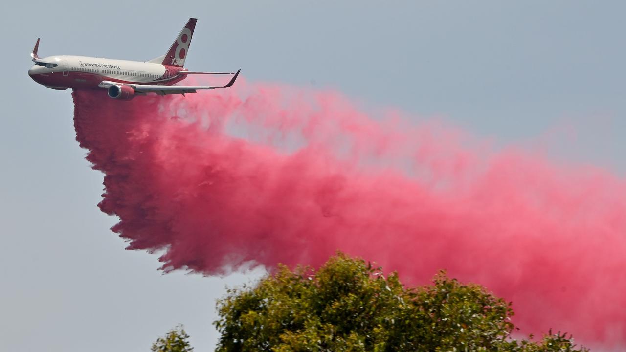 A Rural NSW Fire Service 737 plane drops fire retardant on an out of control bushfire near Taree. Picture: Peter Parks/AFP