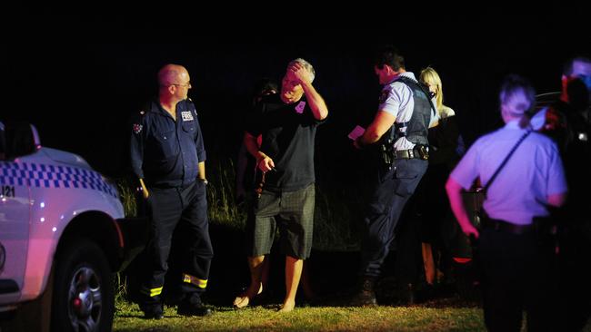 Family members talk to police and emergency services at the scene. Picture: Simon Bullard