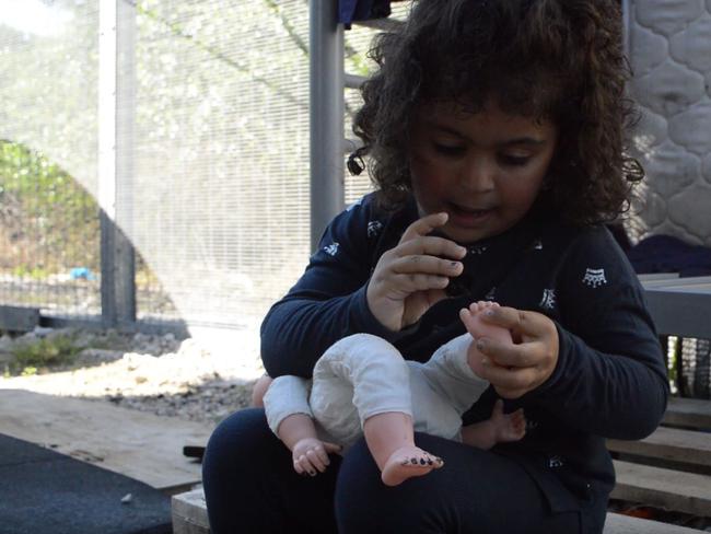 A child plays with a doll in Nauru’s detention centre.