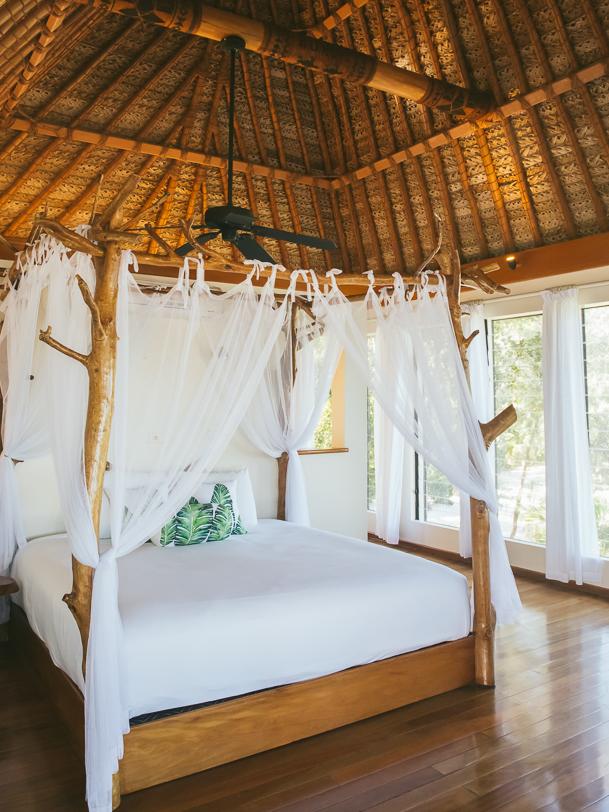 A rustic canopy bed at Turtle Island.