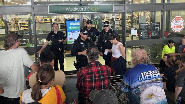 About 200 locals were lined up for food and supplies outside Woolworths in Ingham with police at the door to supervise. Photo Cameron Bates