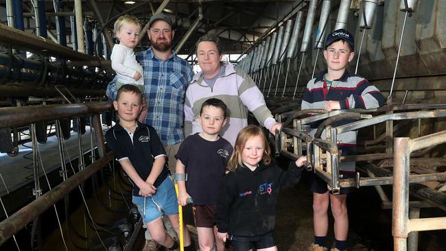 Dairy farmer Jayke Fisher, with his wife Bec, children: Cooper, 12, Max, 8, Harry, 7, (crutches), Ava, 5, Lewy, 2, dog – Allie, at Kyabram. Picture: Yuri Kouzmin