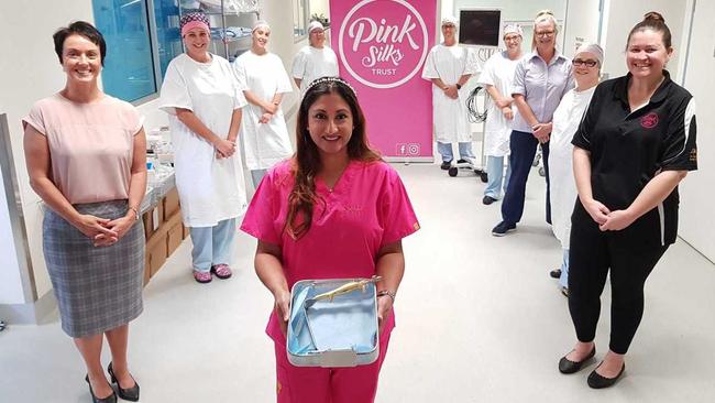 Chair and Co-founder of the Coffs Harbour Pink Silks Perpetual Trust Tanya Johnson (left) and fellow committee member Nicole Pymont (right) with surgeon Shehnarz Salindera (centre) and Perioperative Services team members Kimberley Naylor, Brie Louez, Janice Chew, Kim Batty, Cherie Manuel, Leisl Dowling and Manager Margaret Laidley. Dr Salindera is holding one of the retractors and one of the monitors is at the back with Kim Batty.