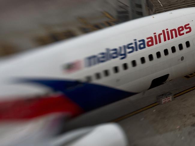 (FILES) This file photo taken with a tilt and shift lens on June 16, 2014 shows a Malaysia Airlines plane parked on the tarmac at Kuala Lumpur International Airport in Sepang. The official search for MH370 may have been called off but experts believe the missing airliner will one day be found, perhaps either by deep-sea miners or treasure hunters lured by a huge cash reward. After spending almost three years and 150 million USD on a deep sea hunt for the Malaysian passenger jet in the remote Indian Ocean off western Australia, top aviation investigators have been forced to admit they have come up with nothing.  / AFP PHOTO / MANAN VATSYAYANA / TO GO WITH Australia-Malaysia-China-MH370-aviation,FOCUS by Glenda KWEK