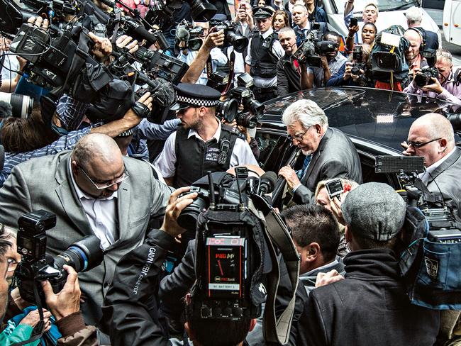 Media spotlight ... Press surround Rolf Harris as he gets into his car after leaving court after being found guilty on 12 sexual misconduct charges. Picture: Richard Pohle