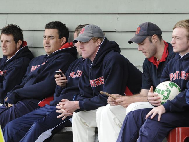 Tense Dandenong players take in the play.