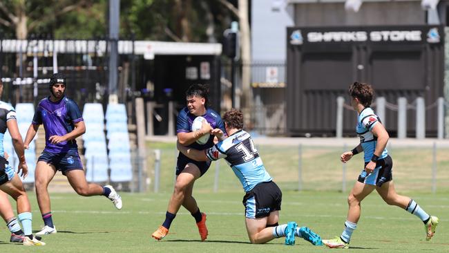 Stanley Huen is tackled by Luke Raymond in the SG Ball Cup. Picture: Steve Montgomery/Ourfootyteam.com. NSWRL junior reps round four - Cronulla Sharks vs Melbourne Storm, Shark Park