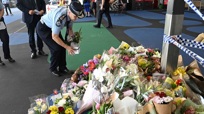 Police Commissioner Katarina Carroll lays flowers at the Redbank scene. Picture: Lyndon Mechielsen