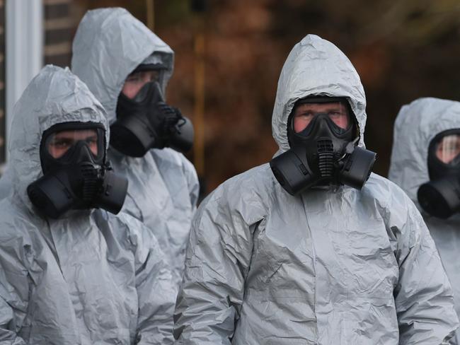 Personnel in protective coveralls and breathing equipment work at the Salisbury District Hospital in Salisbury, southern England after a man and a woman were poisoned in a nerve agent attack. Picture: AFP