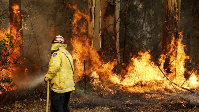 Firefighters were still battling the Hillville bushfire south of Taree while fireworks were being fired off in Sydney. Picture: AAP