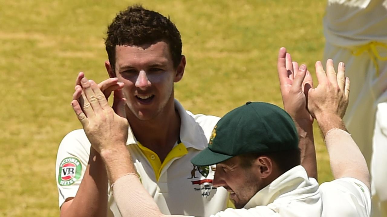 Australia's Josh Hazlewood (L) celebrates after taking the wicket of West Indies' Jason Holder on LBW to end the innings, on day three of the second cricket Test between Australia and the West Indies, June 13, 2015 at Sabina Park in Kingston, Jamaica. AFP PHOTO / ROBYN BECK