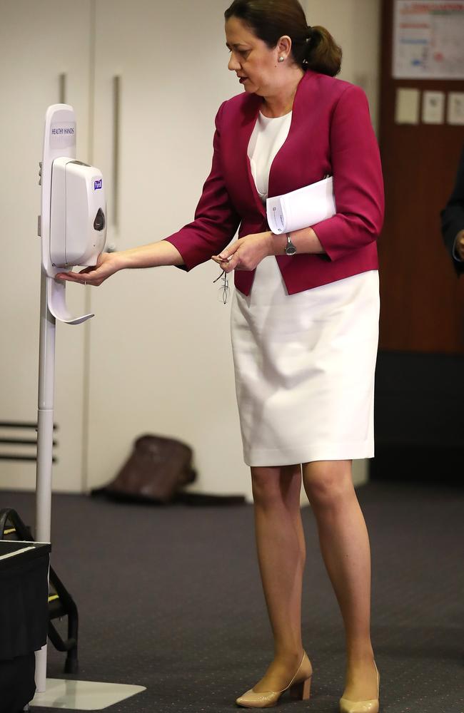 Queensland Premier Annastacia Palaszczuk sanitises her hands before speaking at a press conference at Parliament House on March 25, 2020 in Brisbane. Picture: Jono Searle