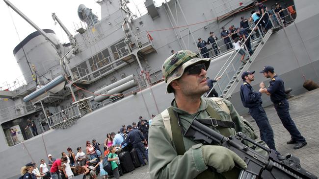 A Greek soldier stands guard as Australians board a Greek navy ship in July 2006. Picture: Greek Armed Forces