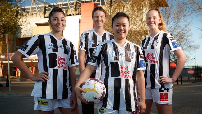 Soccer players Chrissie Zikos, 15, Chelsie Dawber, 18, Alana Lanuzza, 16, and Emily Gale, 15, from Adelaide City in front of Hindmarsh Stadium. Picture: Matt Turner