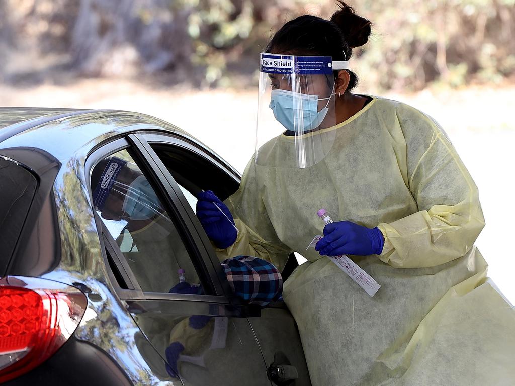 A health worker carries out COVID-19 testing at the Joondalup drive-through clinic. Picture: Paul Kane/Getty Images