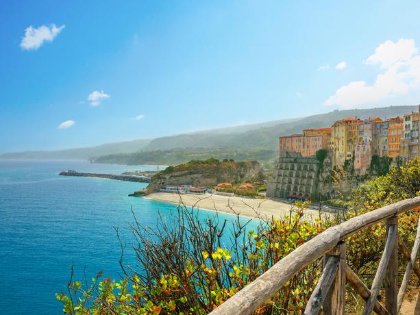 High view of Tropea town and empty beach in sunny day. Calabria, Italy