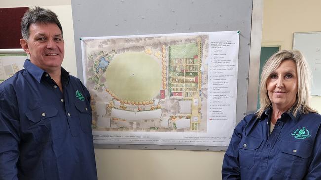 Brendan Ricci and Lisa Mack in front of plans for the agriculture hub.