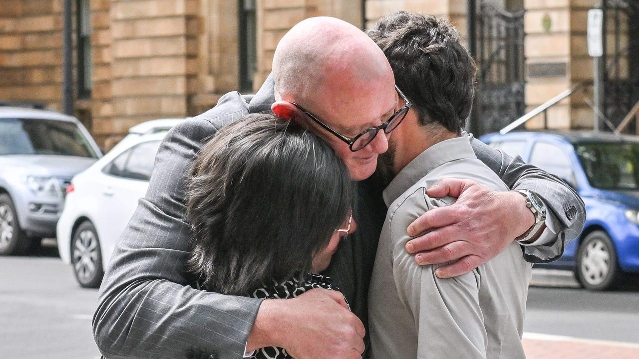 Ms Perrone and Cairo hug their lawyer Michael Woods after the sentence. Picture: NewsWire / Brenton Edwards