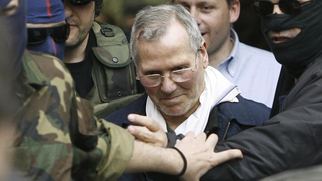 FILE - In this file photo dated Tuesday, April 11, 2006, Mafia boss Bernardo Provenzano is escorted by police security as he enters a Police building in Palermo, Italy, after being arrested. The European court of human rights in Strasbourg ruled Thursday Oct. 25, 2018, that Italy violated the rights of the late Mafia "boss of bosses" Provenzano by maintaining strict anti-Mafia prison conditions in his last few months alive, and the ruling provoked an immediate rebuke from Italian Deputy Premier Luigi Di Maio, who said "the inhumane behaviors were those of Provenzano." (AP Photo/Luca Bruno, FILE)