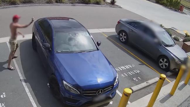 Footage captured Warren (wearing a red cap, face blurred) taking a baseball bat to the elderly man's car following a verbal dispute. Picture: Supplied / Queensland Police