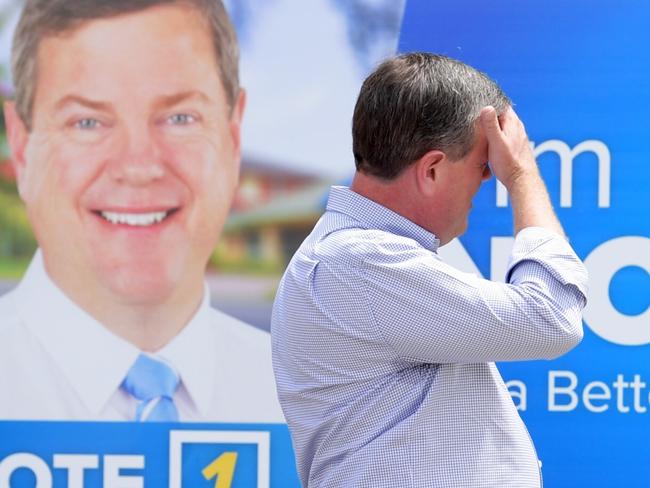 Queensland Opposition Leader Tim Nicholls walks past one of his signs as he visits Ascot State School in Ascot on the final day of the Queensland Election campaign on Saturday, November 25, 2017. Ascot is in the seat of Clayfield, which is held by Nicholls. (AAP Image/Tracey Nearmy) NO ARCHIVING