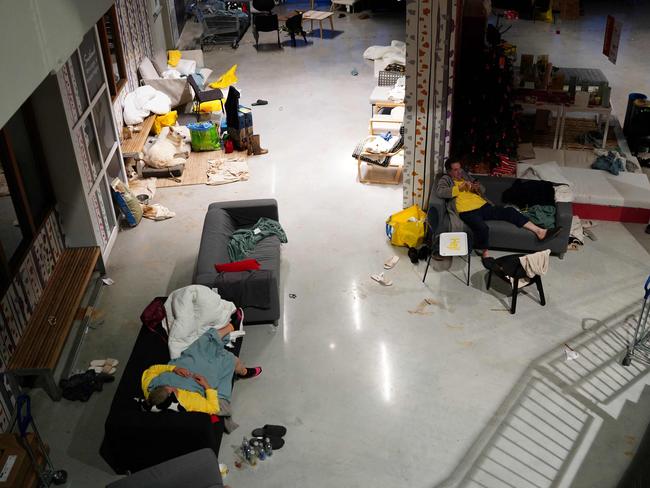 People rest in an emergency shelter in an Ikea store following deadly floods in Alfafar. Picture: AFP