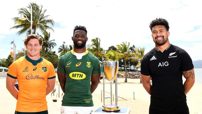 Michael Hooper, Siya Kolisi and Ardie Savea pose next to the Rugby Championship trophy. (Photo by Ian Hitchcock/Getty Images)