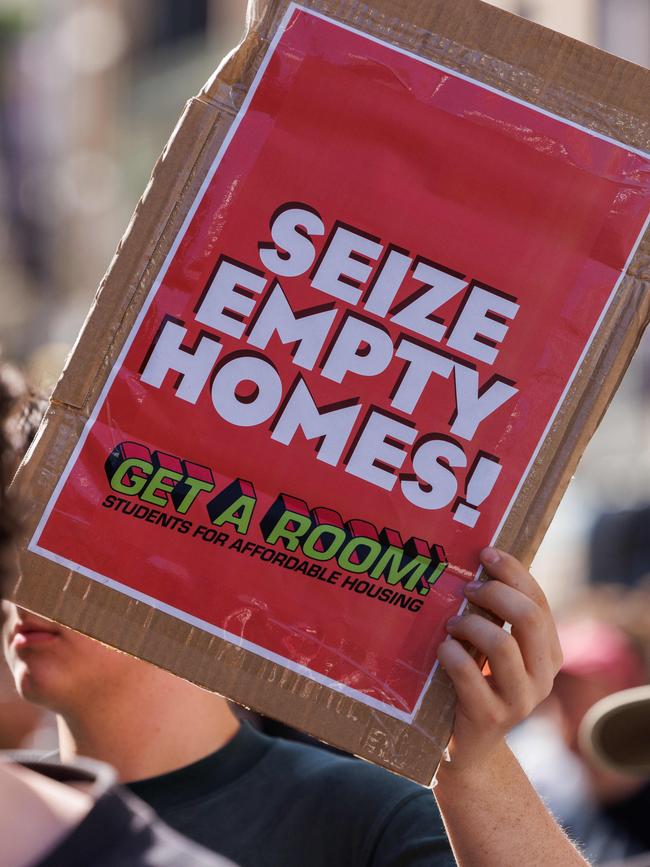 Demonstrators brandished signs outlining their demands. Picture: NCA NewsWire / David Swift