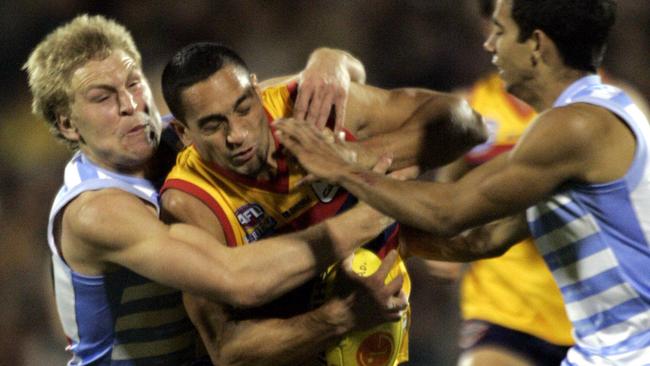 Gotcha! Kane Cornes makes sure Crows star Andrew McLeod can’t get away in Showdown 18. Picture: Sam Wundke