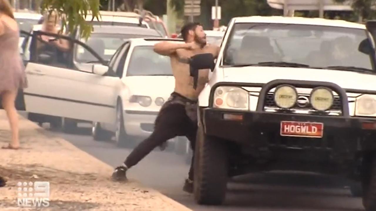 A shirtless man was allegedly filmed using a metal pole as a weapon before throwing punches through a driver’s window