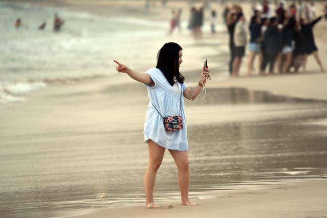 Revellers capturing a sunrise selfie on New Years Day at Bondi Beach in Sydney. Picture: AAP