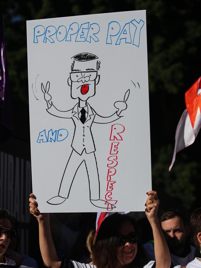 A placard depicting a cartoon of Premier Perrottet at the rally. Picture NCA Newswire/ Gaye Gerard.