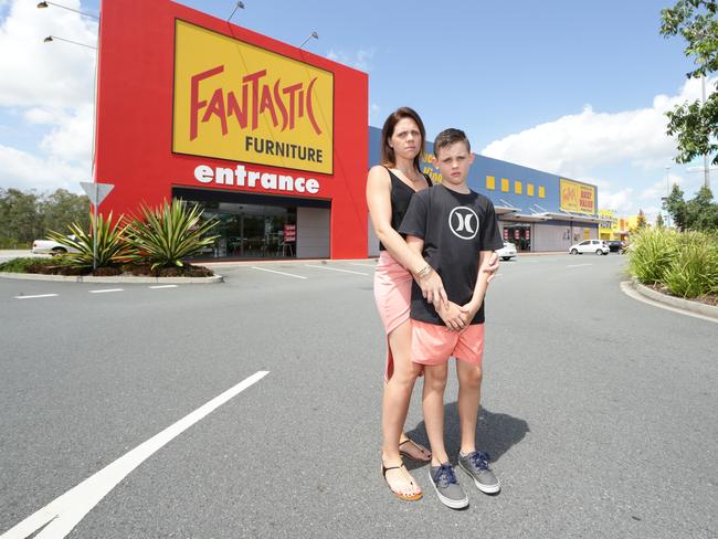 Jaclyn Gross and her son Trae McGovern, 11. Part of one of Trae’s toes was sliced off by a Fantastic Furniture Worx chair. Picture: Luke Marsden.