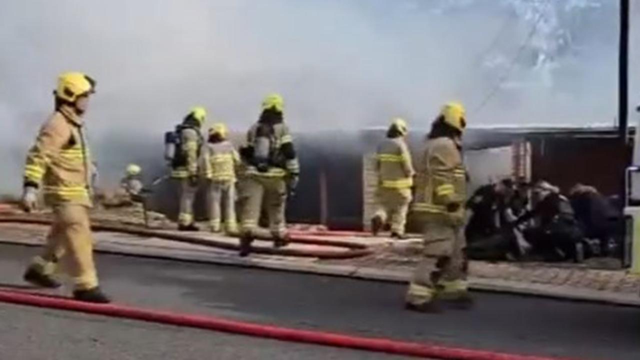 A woman and a police officer have been hospitalised after a house fire in Athelstone on Sunday afternoon. Picture: 7NEWS