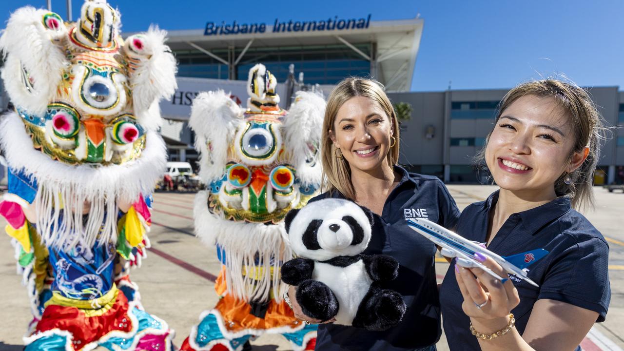 Brisbane Airport Corporation’s Stacey Pollard (Head of Terminal Operations), Vickey Wong and a lion dance troop from LTL Group celebrate the return of China Southern flights.