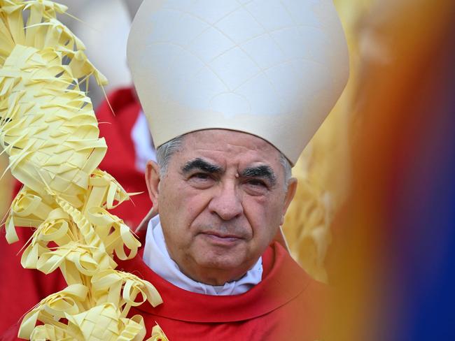 (FILES) Italian Cardinal Giovanni Angelo Becciu takes par in the procession of the Palm Sunday mass on April 2, 2023 at St. Peter's square in The Vatican. A landmark Vatican fraud trial involving Cardinal Angelo Becciu and a murky London property deal wrapped up on December 12, 2023 after more than two years, with a verdict expected on December 16. The offences relate to the Church's loss-making purchase of a luxury property in London's upmarket Chelsea district, funded in part by Peter's Pence donations, money given by churchgoers for the pope's charities. (Photo by Filippo MONTEFORTE / AFP)