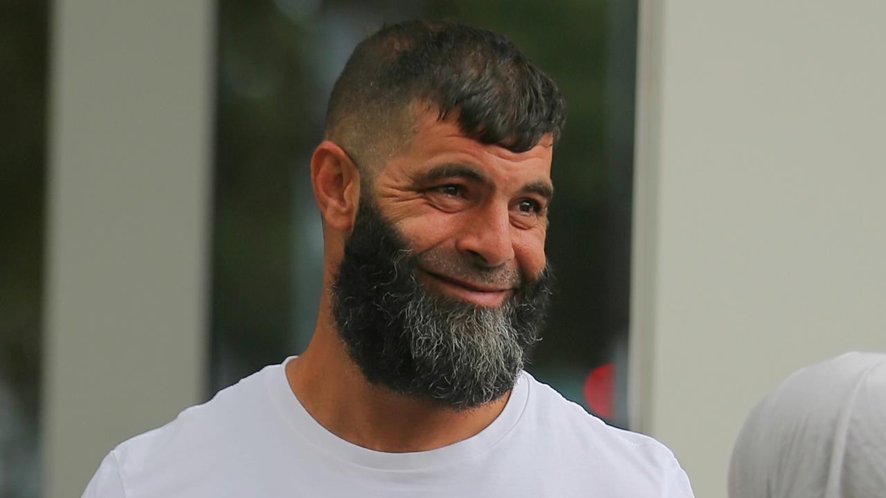 Ahmad Rock Ahmad (white tee shirt) leaves custody outside Bankstown court .pic John Grainger