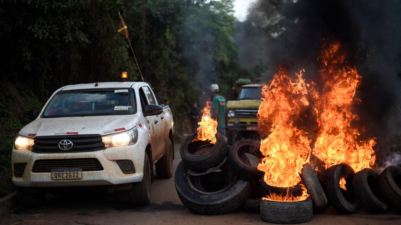 Residents of Corrego do Feijao burn tyres during a protest at the gates of mining company Vale. Picture: Douglas Magno/AFP