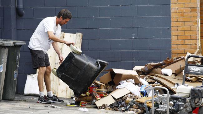 A man cleaning up outside a business in Milton. Picture: Tertius Pickard